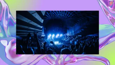A crowd watching a performance inside the Sydney Opera House Concert Hall from the back of the theatre.