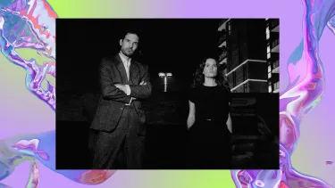 A black-and-white photo of a man and woman standing confidently against a dark urban backdrop. The image overlays a background of a purple iridescent swirl, looking like water.