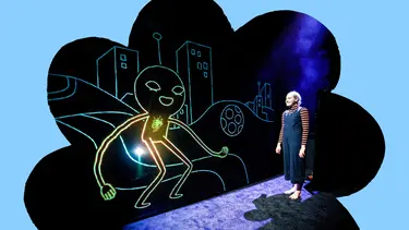 A lady stands staring at a glow in the dark figure projected on the wall smiling at her.