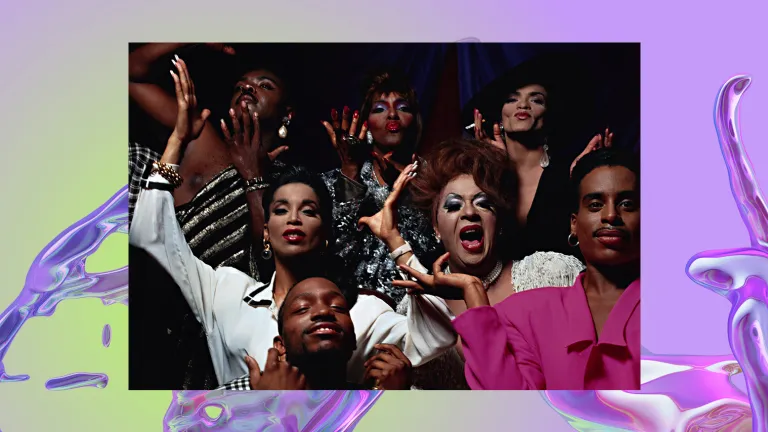 Seven people pose for the camera with their hands in the air.