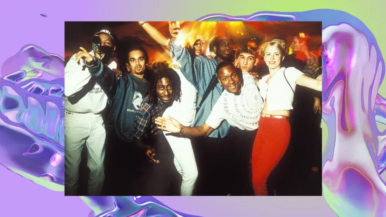 A group of people at a rave pose for a picture.