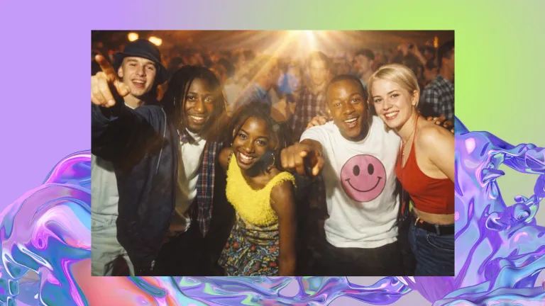 A group of people at a rave pose for a picture.