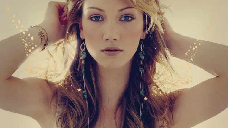 Delta Goodrem a blonde Australian singer in a white dress.