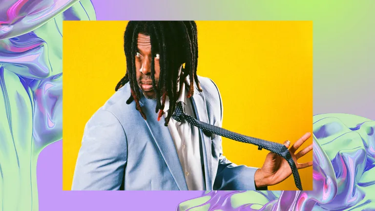 A man in a light blue suit holds his tie standing against a vibrant yellow background. The image is overlayed against a backdrop with a purple, iridescent swirl, looking like water.