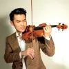 A man in brown suit playing a violin.