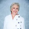 Jane Caro a commentator with grey hairs wearing a white shirt.