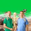 Two men and a skeleton look surprised. There are dinosaurs and mist in the background.