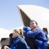 School girls sitting outside on the stairs of the Sydney opera house.