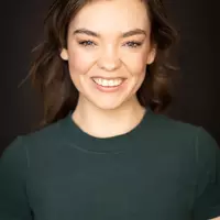 An Australian actress Chloe Hayden wearing a dark green t-shirt.