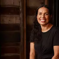 A Wirangu and Mirning woman with long black hair smiling at the camera