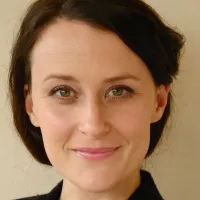A woman with black hairs and green eyes.