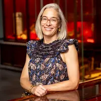 Sophie gee smiling in front of red lit background