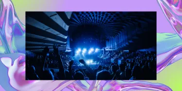 A crowd watching a performance inside the Sydney Opera House Concert Hall from the back of the theatre.