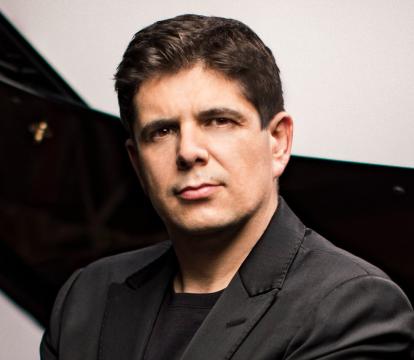 Pianist Javier Perianes sits in front of a grand piano