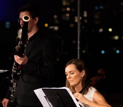 A horn, bassoon, cello, and double bass musician play in the Utzon Room
