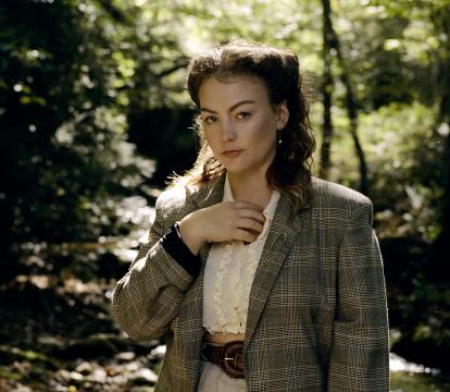 American singer-songwriter Angel Olsen standing near a river bed.