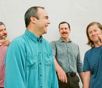 Four men from a pop band Future Islands standing together.