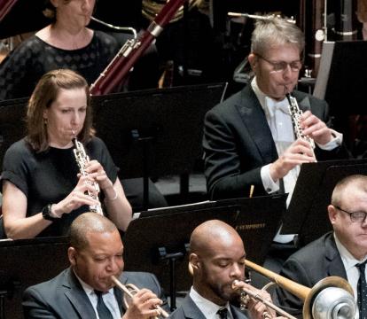 An orchestra playing flute.