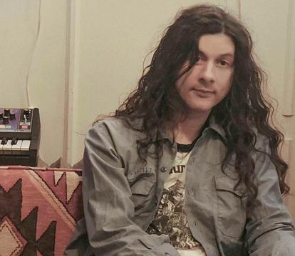 Kurt Vile an American singer sitting in his studio.