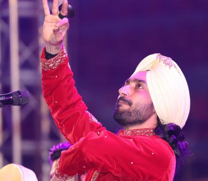 A man in a turban holds a microphone