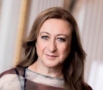 A blonde woman in a brown dress.