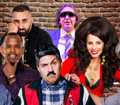 A group of seven men and two women pose in front of a brick wall.