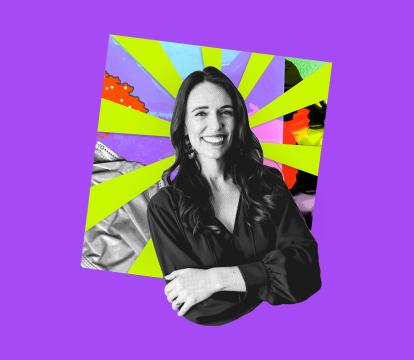 Black and white image of a smiling woman with crossed arms, set against a vibrant, multicoloured background.