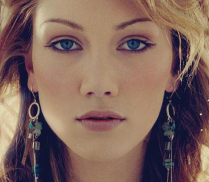 Delta Goodrem a blonde Australian singer in a white dress.