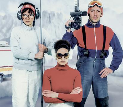 Three news reporters on a broken iceberg floating off to sea