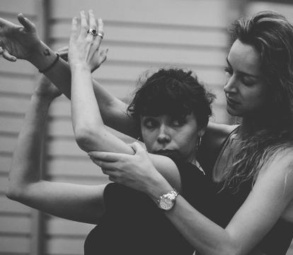 Two women dancing in a studio.