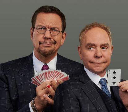 Two men in suit holding play cards, make funny faces.