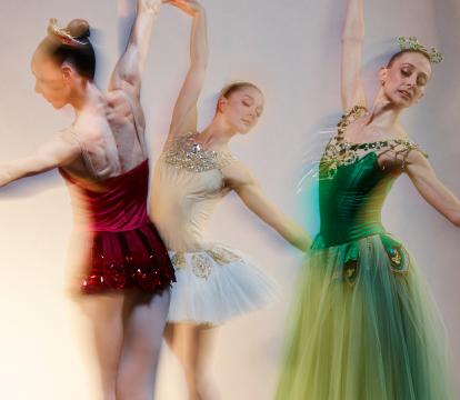 Three ballerinas doing ballet.