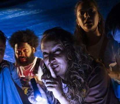 People in a blue room with a blue light, creating a serene atmosphere.