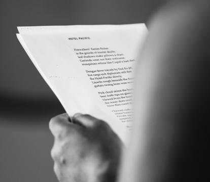 An image of a man holding a script. We don't see the man but we see the script.