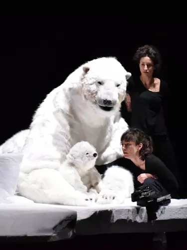 A large puppet of a polar bear with its cub