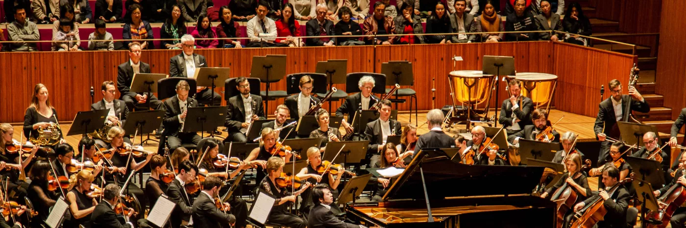 Lang Lang plays piano in front of the Sydney Symphony Orchestra in the Sydney Opera House Concert Hall