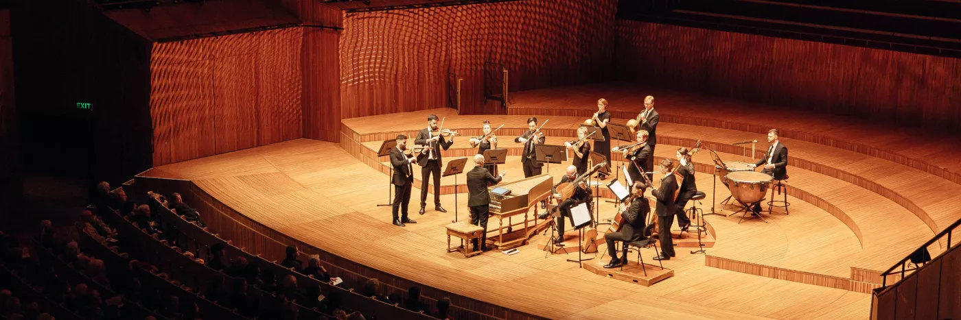 A small chamber orchestra with Harpsichord stand at the Sydney Opera House concert hall