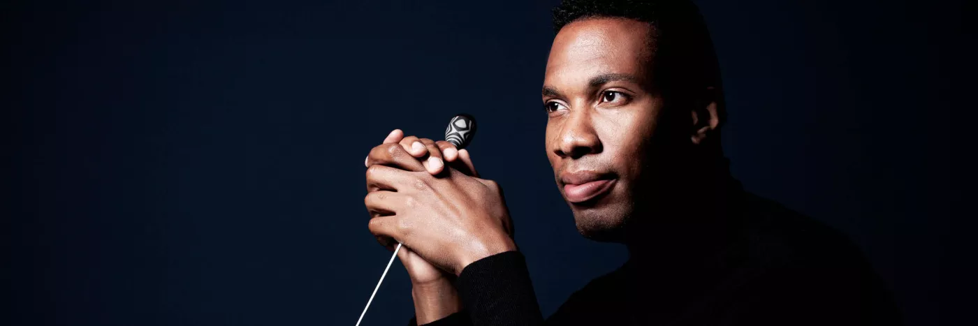 A close up of conductor Roderick Cox