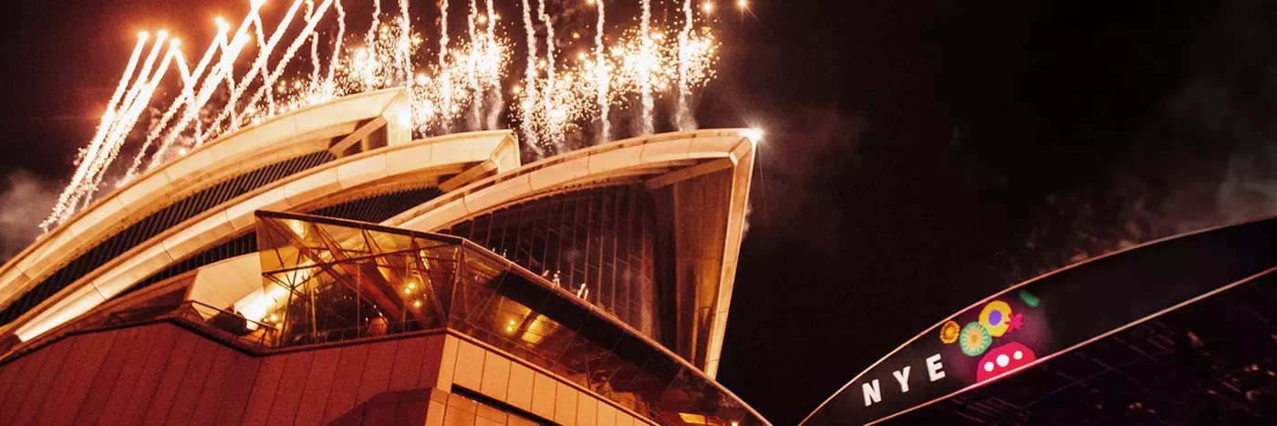 Fireworks are going off above the Sydney Opera House sails.