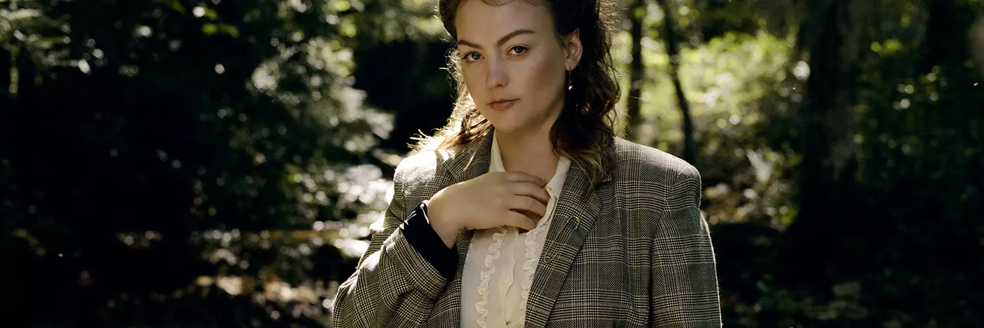 American singer-songwriter Angel Olsen standing near a river bed.