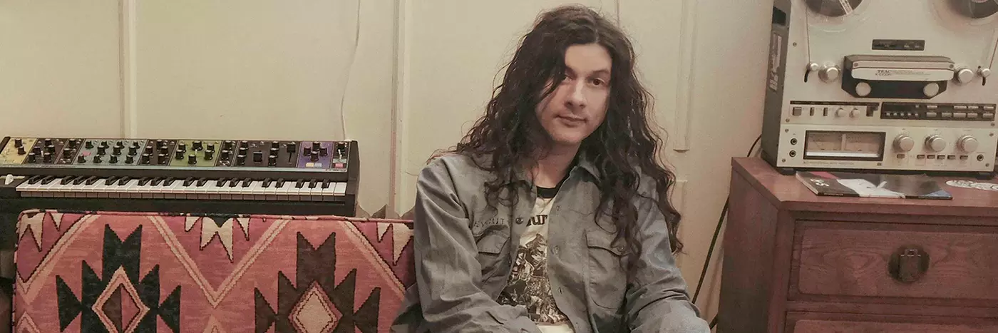 Kurt Vile an American singer sitting in his studio.