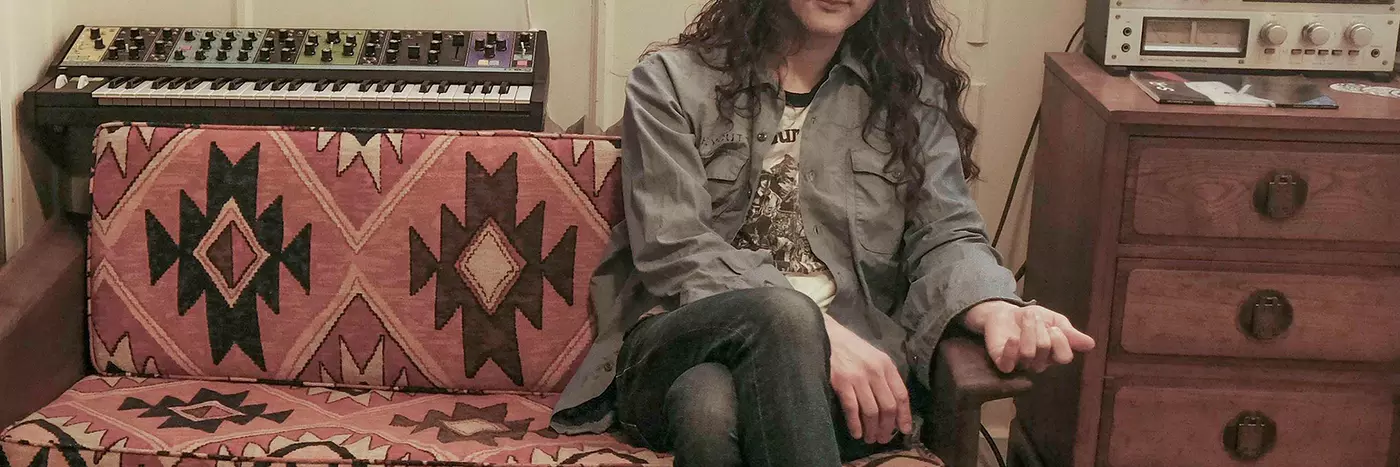 Kurt Vile an American singer sitting in his studio.