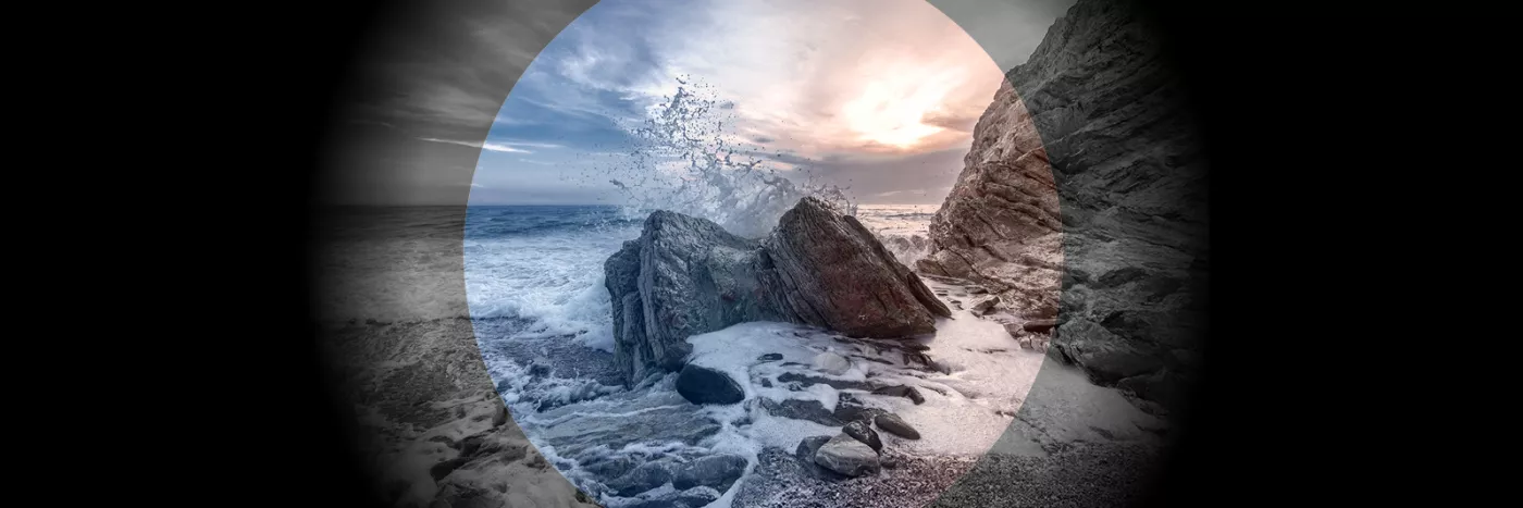 An image of a wave crashing against a rocky shore