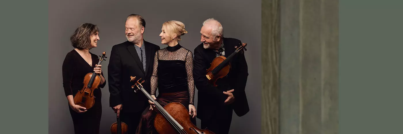 A group of musicians in black holding their instruments.