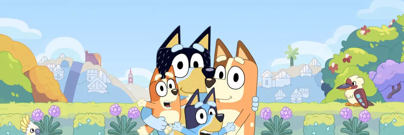 Four cartoon dogs gathered together in a field.