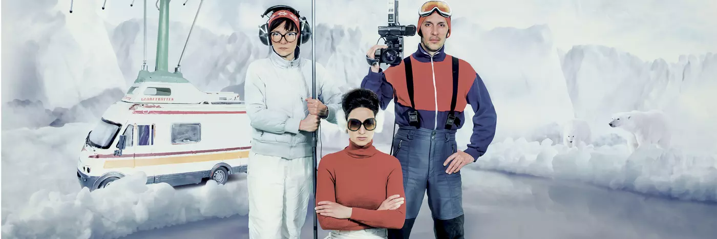 Three news reporters on a broken iceberg floating off to sea