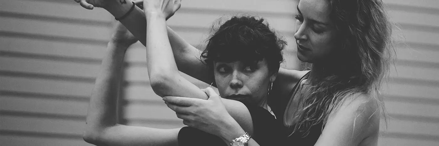 Two women dancing in a studio.