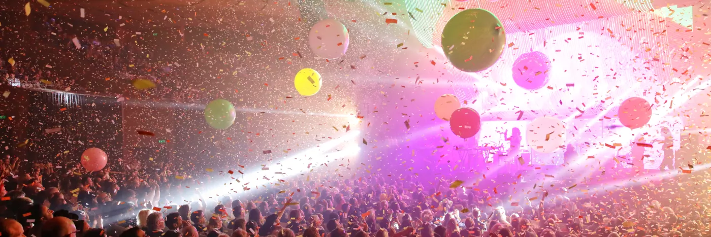 A crowd of people in the Concert Hall enjoying a performance.