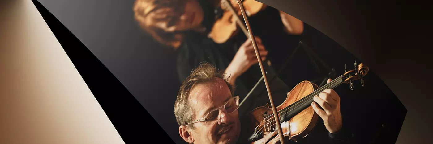 A man and a woman playing a violin.