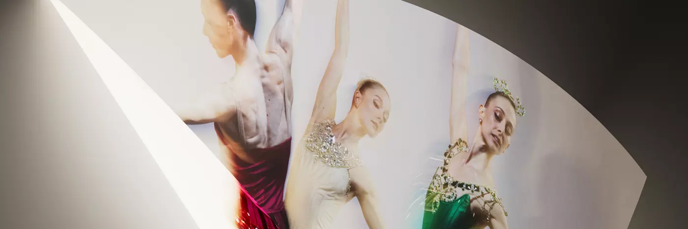 Three ballerinas performing ballet.